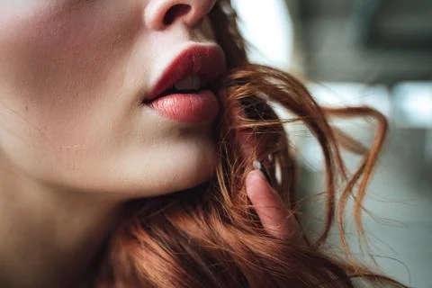 Closeup of partly opened full lips with distinctive red lipstick. Young pretty Stock Photos