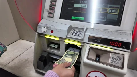 Closeup passenger hand adding Japanese yen into ticket vending machine Stock Footage 274932559