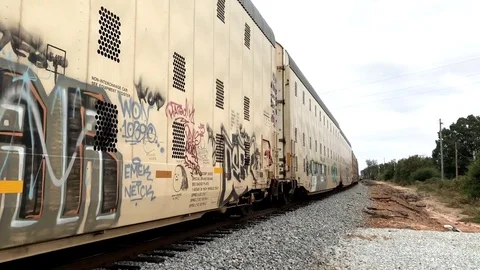 Closeup of Passing Train with Gang Graffiti Stock Footage 81415633