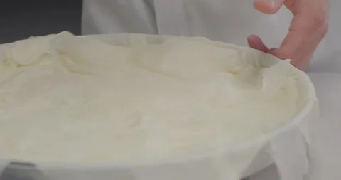Closeup pastry chef arrange thin phyllo dough sheets on a tray to prepare Stock Footage 287496321