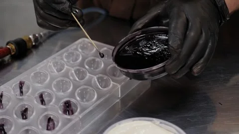 Closeup of a pastry chef makes handmade chocolates in a professional pastry shop Stock Footage 269492513