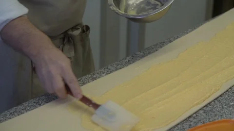 Closeup of pastry chef making roll cake with pastry dough Stock Footage 107545272