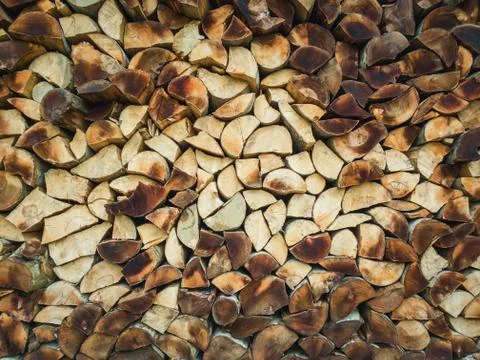 Closeup pattern of a stack of split logs, old dusty firewood. Pile texture of Stock Photos