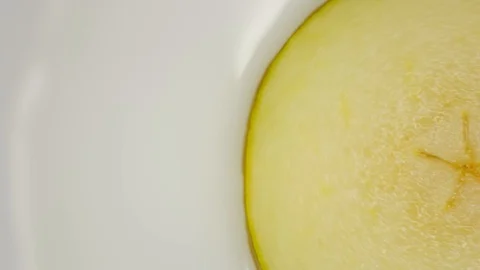Closeup of pears with water. Rotating on a turntable, on a white background. Stock Footage 125885366