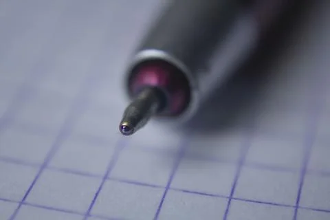 Closeup of a pen tip over a notebook 库存照片