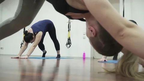 Closeup of people making warm up exercises in fitness hall Stock Footage 73548454