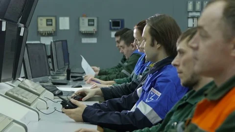 Closeup People Sit at Computers Inspect Production Process Stock Footage 79500937