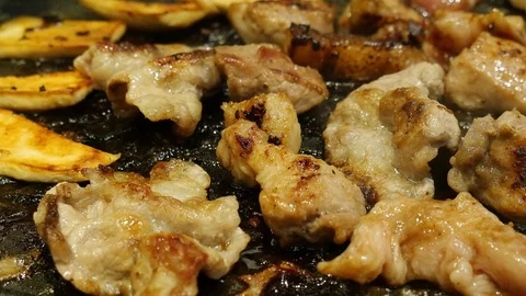 Closeup of people using chopstick grill fresh delicious meat and mushroom on Video stock 101005767