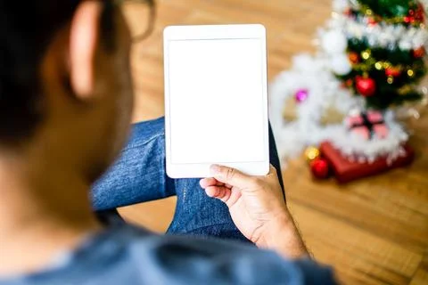 Closeup, People using the device home. A man sitting relaxed and holding a .. Stock Photos