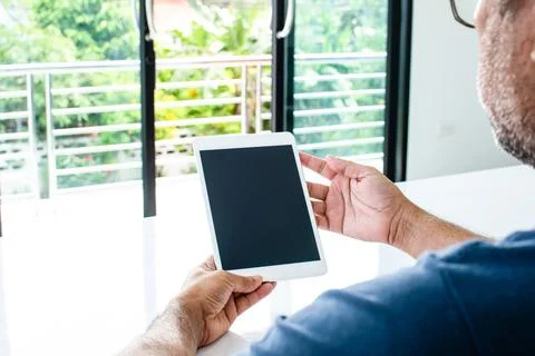 Closeup, People using the device home. A man holds a tablet to use the inte.. Foto stock