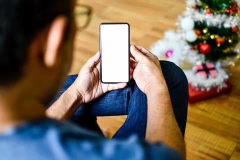 Closeup, People using the device home. A man sitting relaxed and holding a .. Stock Photos