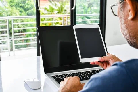 Closeup, People using the device home. A man holds a tablet to use the inte.. Stock Photos