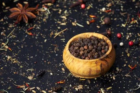 Closeup a pepper shaker with spices on an old dark background. Stock Photos