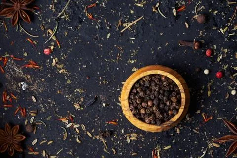 Closeup a pepper shaker with spices on an old dark background. Stock Photos