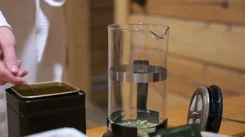 Closeup up of a person adding dry tea leaves into glass pot. Making the tea Vídeo Stock 156606701