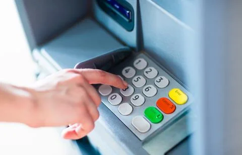 Closeup of a person entering PIN code on ATM bank machine Stock Photos