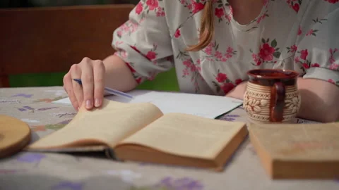 Closeup person study write read book hands on desk outside Stock Footage 155806056