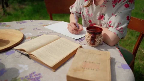 Closeup person study write read book hands on desk outside Stock Footage 155806143