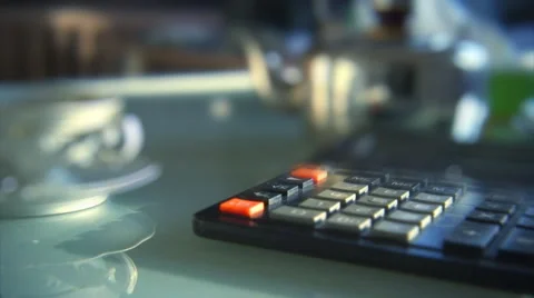 Closeup of a person using a calculator and drinking tea. Shallow focus. Stock Footage 44561378