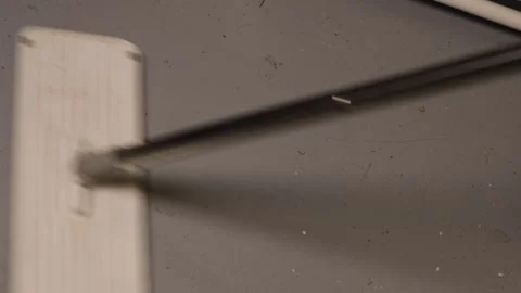 Closeup of a person using a flat white mop on a light-colored floor surface, Video stock 327682876