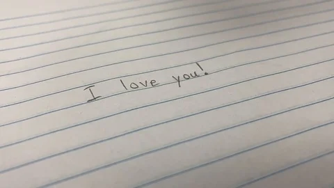 Closeup of a person's hand drawing a heart next to a love letter romance, Video stock 124824872