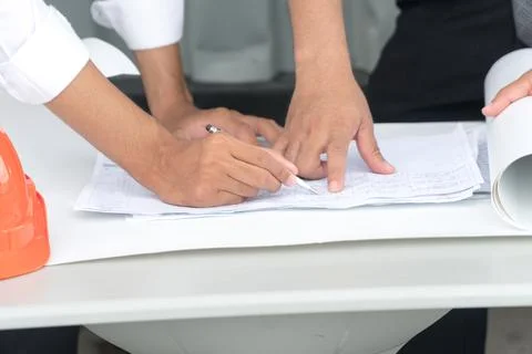 Closeup of a person's hands pointing on blue print. Hands of two construction Stock Photos