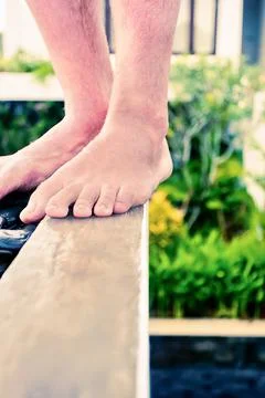 Closeup of a person's legs on a wall Stock Photos