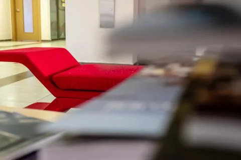 A closeup perspective shoot of a red sofa - focus on edge of sofa. photo has  Stock Photos