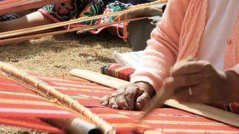 Closeup of Peruvian Women Carefully Working with Loom Stock Footage