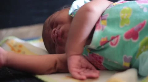 CloseUp pf Cute Week Old Baby as she sleeps stretches and dreams Stock Footage 61773011