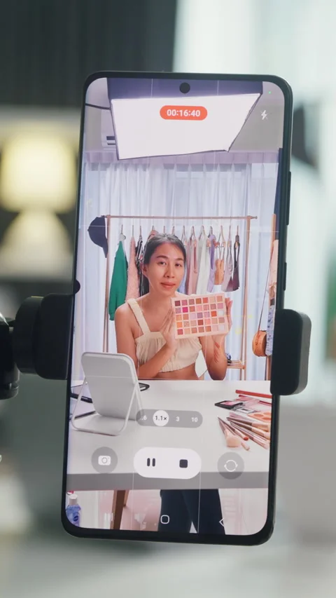 Closeup phone screen record Asia lady vlogger review new product eye shadow. Stock Footage 344794121