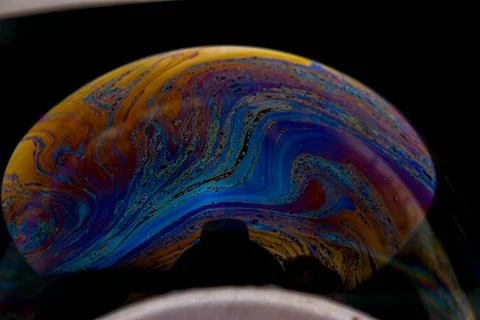 Closeup photo of colored light reflection on the surface of soap bubble Foto stock