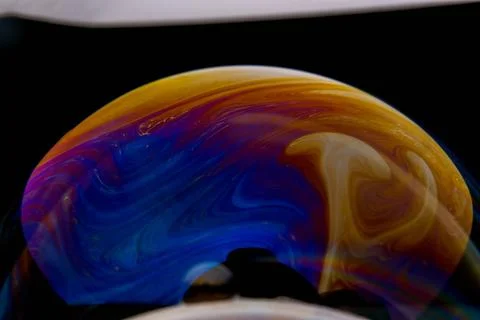 Closeup photo of colored light reflection on the surface of soap bubble 스톡 사진
