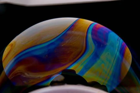 Closeup photo of colored light reflection on the surface of soap bubble 스톡 사진
