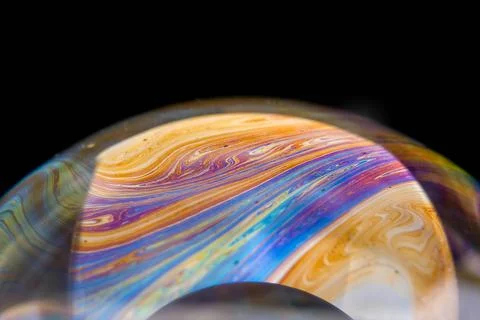 Closeup photo of colored light reflection on the surface of soap bubble Foto stock