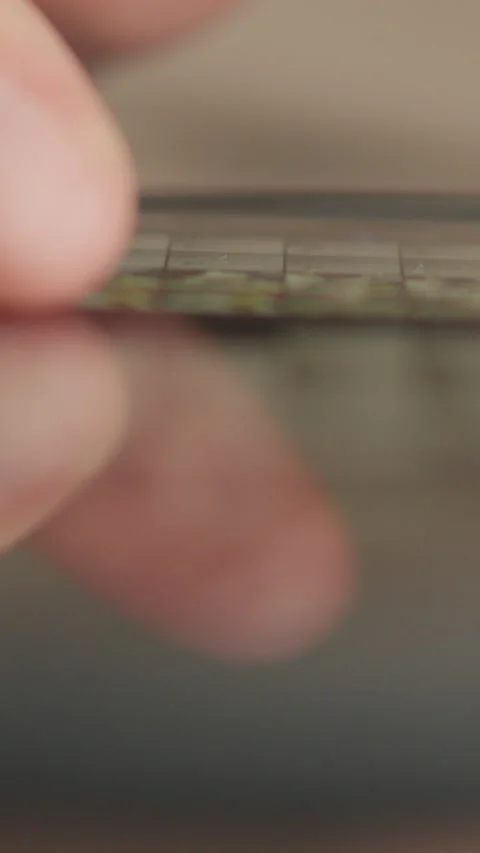 The closeup photo depicts hands using a smartphone indoors, interacting with Stock Footage 279218106