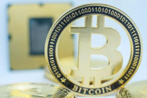 Closeup of physical bitcoin and computer cpu processor 库存照片