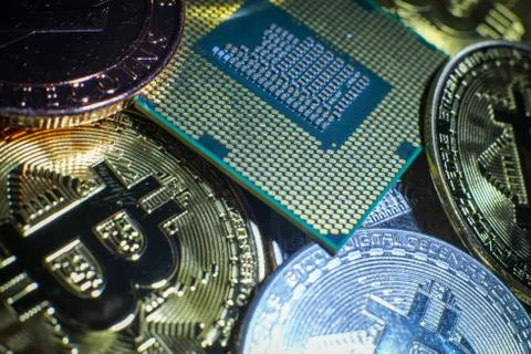 Closeup of physical bitcoin and computer cpu processor 写真素材