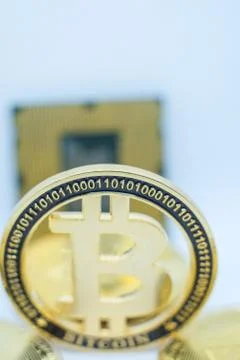 Closeup of physical bitcoin and computer cpu processor Stock Photos