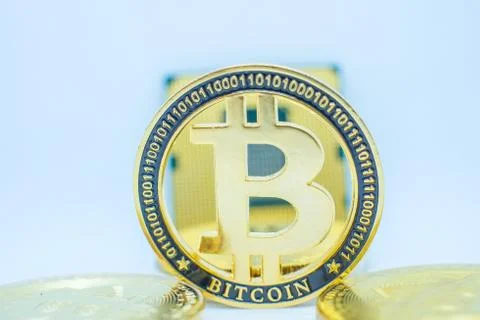Closeup of physical bitcoin and computer cpu processor 写真素材