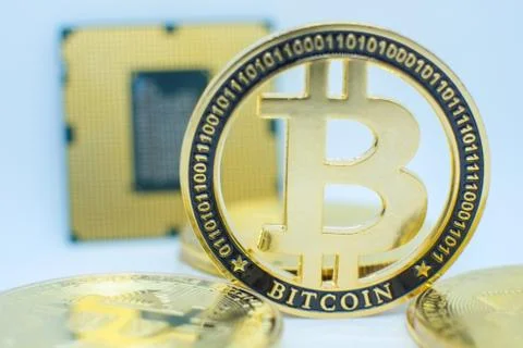 Closeup of physical bitcoin and computer cpu processor Stock Photos