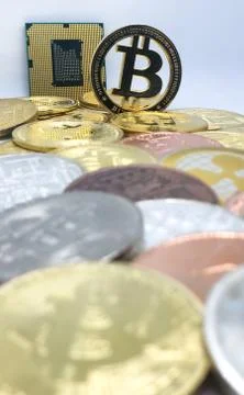 Closeup of physical bitcoin and computer cpu processor Stock Photos