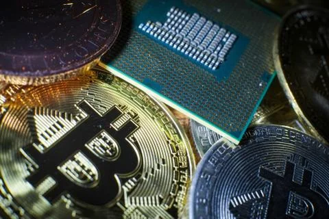 Closeup of physical bitcoin and computer cpu processor Stock Photos