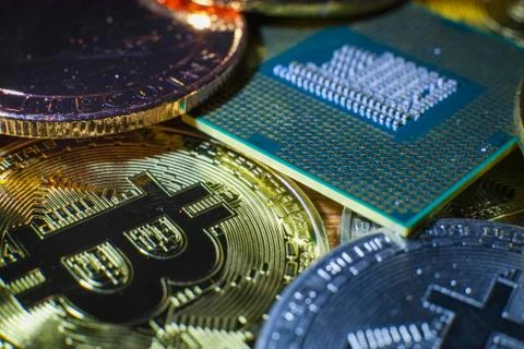 Closeup of physical bitcoin and computer cpu processor 写真素材