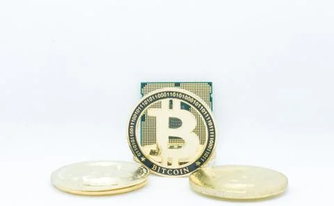 Closeup of physical bitcoin and computer cpu processor Stock Photos