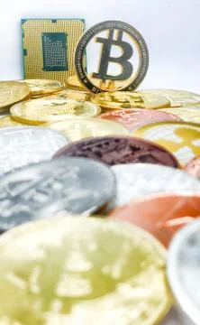 Closeup of physical bitcoin and computer cpu processor Stock Photos