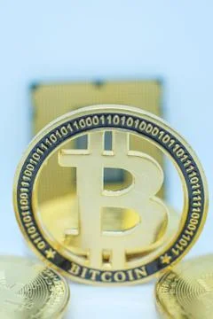 Closeup of physical bitcoin and computer cpu processor 스톡 사진