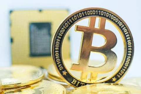 Closeup of physical bitcoin and computer cpu processor 写真素材