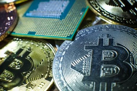 Closeup of physical bitcoin and computer cpu processor Stock Photos