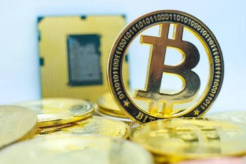Closeup of physical bitcoin and computer cpu processor Many golden bitcoin... 스톡 사진